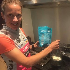 Britta Martin, triathlete holding USANA Whey Protein Booster
